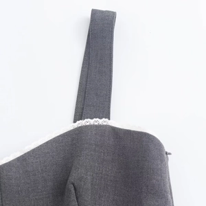 Detailed view of white lace trim on a grey sundress neckline with an invisible side zipper