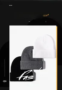 Detail of ribbed knit winter hats in black, white and grey showing fabric texture