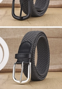 Detail view of woven elastic belts in black and grey with leather trim and metal buckles