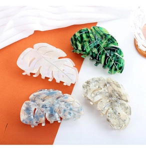 Detail of tortoise monstera leaf hair clips in marble acetate with silver vein patterns