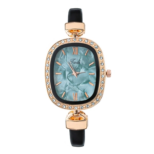 Elegant rose gold oval watch with teal marble dial and sparkling rhinestone bezel