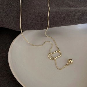 Minimalist gold snake chain sweater necklace featuring hollow oval link and polished bead