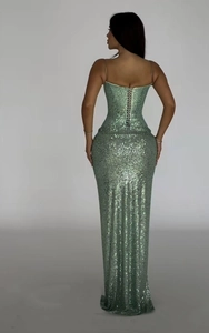 Detail of mint green sequin dress showing the slim fit back and lace-up strap design