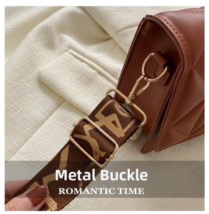 Detail of golden metal hooks and quilted diamond pattern on a brown leather bag