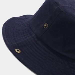 Solid navy cotton bucket hat featuring a vintage bronze metal buckle with clear texture