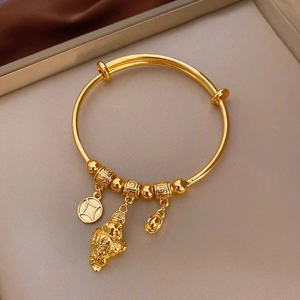 Detailed close-up of gold-plated bracelet with Pixiu and copper coin lucky charms