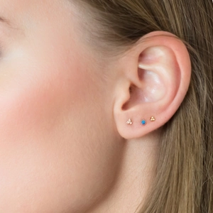 Three-piece gold silver stud set featuring turquoise, clover and beads on ear