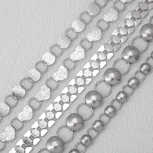 Various textured stainless steel jewelry chains including heart and bead designs