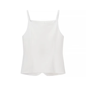 Detail shot of a white sleeveless crop top with thin straps and smooth fabric texture