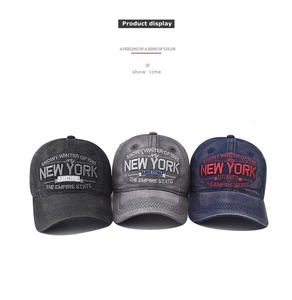 Close-up of vintage washed cotton baseball caps with layered NEW YORK embroidery