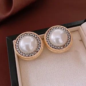 Vintage style round pearl stud earrings with silver chain and gold spiral border detail