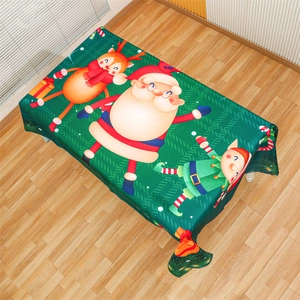 Detail der Weihnachts-Tischdecke mit Weihnachtsmann und Rentier-Print auf grünem Stoff