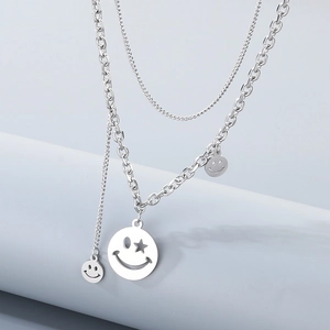 Close-up of double-layer silver necklace with hollow star smiley face pendants