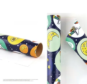 Detailed view of 80g art paper gift wrap with space rocket and planet cartoon prints