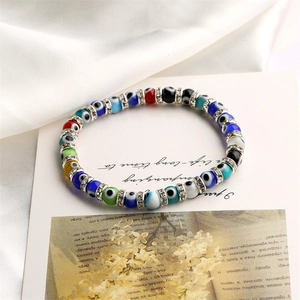 Macro detail of multi-colored Evil Eye beads with crystal-studded silver spacers