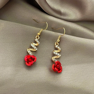 Elegant gold long earrings with red rose pendant and rhinestone tassels on champagne silk