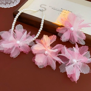 Detail of pink organza flower choker with pearls and layered handmade mesh petals