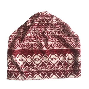 Detailed view of red and white ethnic geometric pattern on versatile slouchy beanie hat