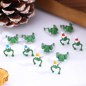 Detailed view of colorful frog enamel earrings with festive hats and polished finish