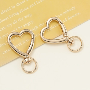Polished golden heart-shaped lobster clasp with a swivel ring for DIY keychains