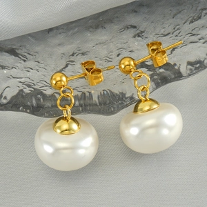 Elegant gold stainless steel pearl drop earrings for women on a grey silk background