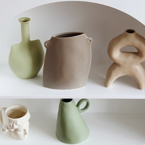 Morandi ceramic vases in geometric and David bust shapes on a modern minimalist display shelf