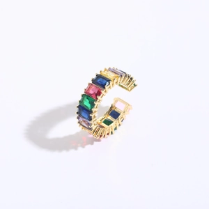Detail of 14K gold plated ring with rainbow baguette-cut zircon stones on white background