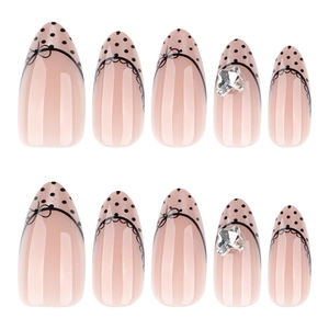 French cat-eye almond press-on nails with black polka dots and 3D bow rhinestones