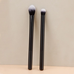 Detailed view of dual makeup brush set with black and white gradient synthetic bristles