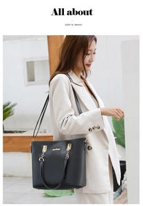 Detail of elegant black PU leather handbag featuring gold metal chain links and brand logo