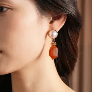Vintage gold drop earrings with large white pearl and faceted amber resin pendants