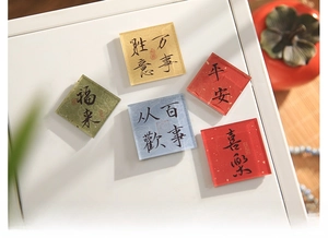 Detailed view of 5-piece Chinese calligraphy acrylic magnets with glossy finish on white surface
