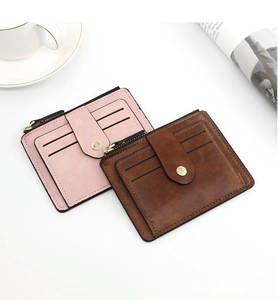 Detail view of pink and brown leather wallets with multiple card slots and zipper pocket