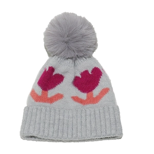 Close-up of grey knit hat featuring pink tulip flowers and a soft faux fur pom-pom