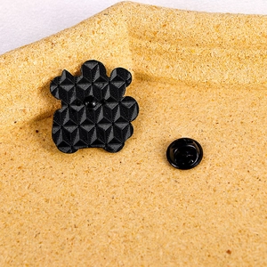 3D geometric black bear enamel brooch pin with butterfly clasp on wooden background