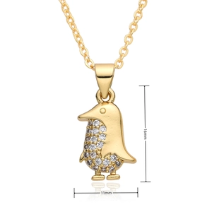 Detailed view of tiny gold penguin pendant with zircon inlay and 16mm x 11mm dimensions