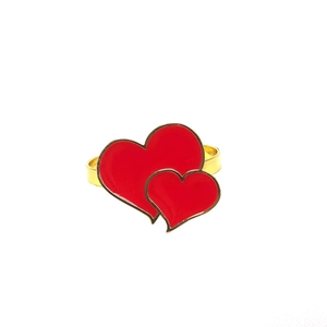 Close-up of golden napkin ring featuring vibrant red double heart enamel detailing