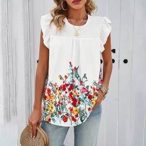 Close-up of white floral sleeveless top featuring ruffled trim and pleated yoke detail