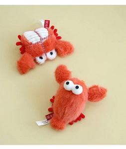 Detail of plush crab and lobster catnip toys with soft fur texture and vivid red colors