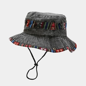 Detailed texture of dark grey washed denim bucket hat with colorful ethnic embroidery