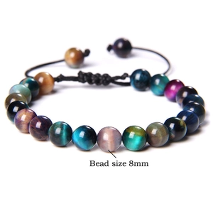Macro view of 8mm multicolored tiger eye beads on an adjustable braided cord bracelet