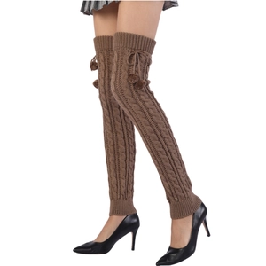 Brown cable knit over-knee leg warmers with pom-poms for women, stylish winter look