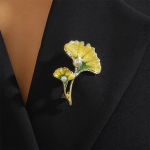 Ginkgo leaf enamel brooch with pearls and rhinestones on a black suit lapel
