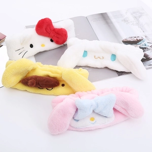 Detail view of plush headbands featuring Hello Kitty and My Melody on a magazine background