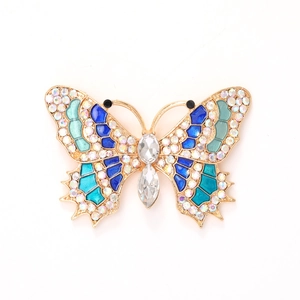 Golden butterfly jewelry accessory with blue enamel and sparkling crystals