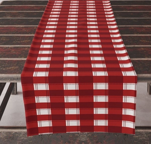 Close-up of red and white plaid table runner on a dark wood table for holiday decor