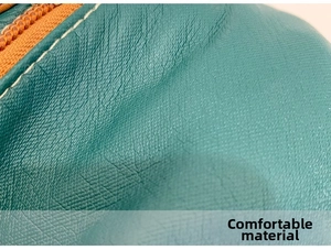 Detailed macro shot of premium lychee texture leather with contrast stitching and zipper