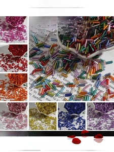 Close-up of silver-lined 2x7mm glass bugle beads in various vibrant colors for DIY crafts