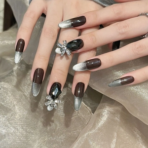 Dark brown and silver cat eye press-on nails with luxury black rhinestone bow detail