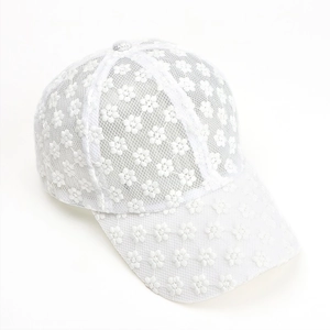 Close-up of white floral lace baseball cap showing intricate embroidery and mesh texture